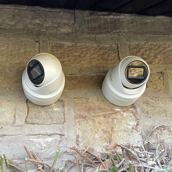 two cctv cameras installed on a wall